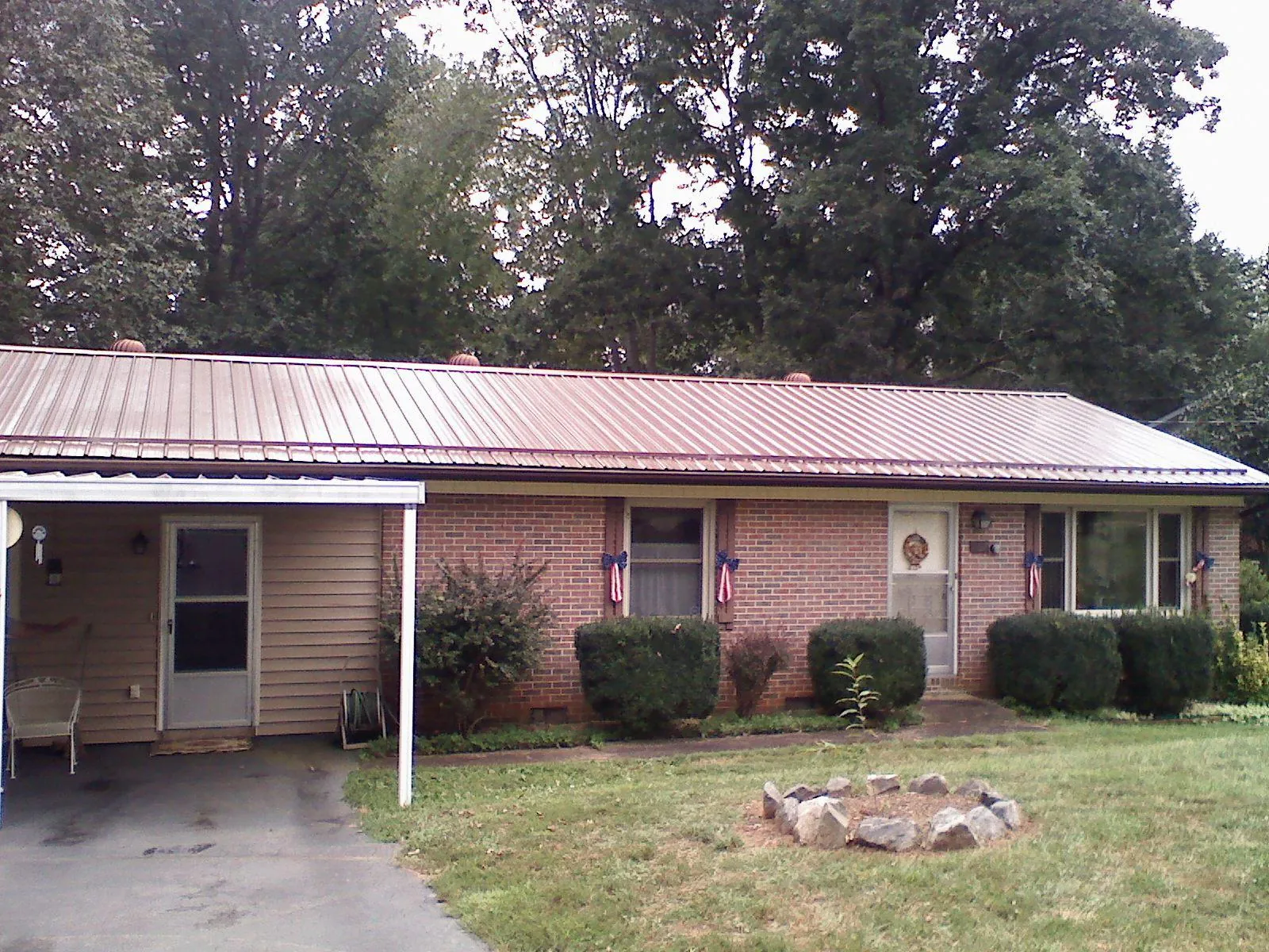 Bronze metal roof and carport on a brick ranch home — Roof Repair work by our crew in Santa Paula