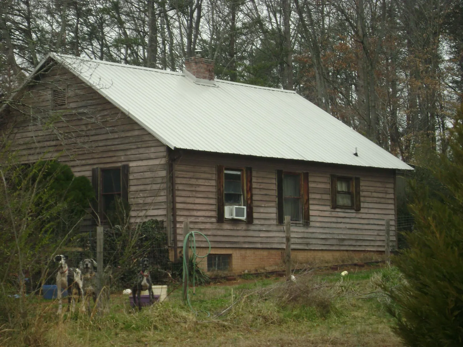 White metal roof on an old wood sided farmhouse, from a Metal Roof Installation job in Santa Paula